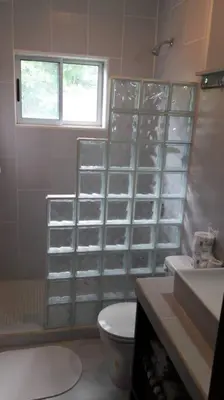 a bathroom with a toilet and a sink and a window at #8 Ocean view Beach Front Bungalow 2nd Row in Playa Hermosa