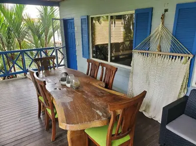 a wooden table and chairs on the porch of a house at #8 Ocean view Beach Front Bungalow 2nd Row in Playa Hermosa