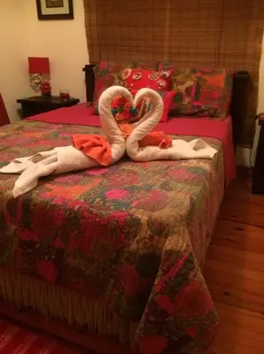 two swans sitting on a bed in a bedroom at #28 Beach Bungalow in Playa Hermosa