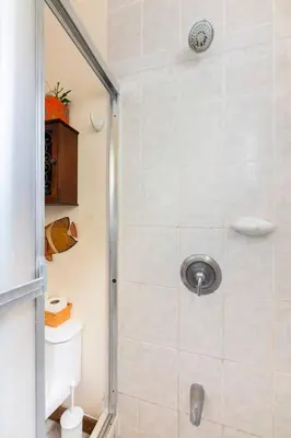 a bathroom with a shower with a glass door at #28 Beach Bungalow in Playa Hermosa