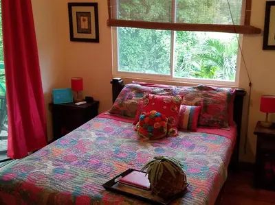 a bedroom with a bed with a book on it at #28 Beach Bungalow in Playa Hermosa