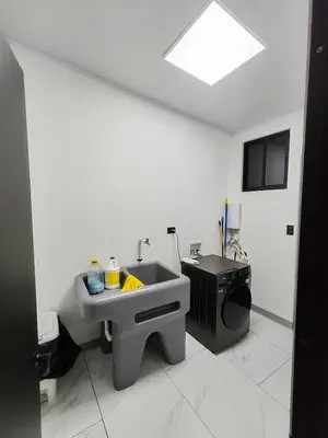 a bathroom with a sink and a stove at Casa Pacifica in Uvita