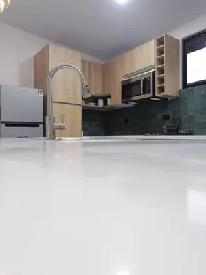 a kitchen with a sink and a stainless steel appliance at Casa Pacifica in Uvita