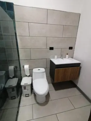 a bathroom with a toilet and a sink at Casa Pacifica in Uvita