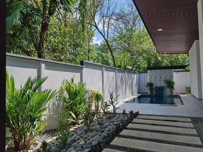 a backyard with a swimming pool and a fence at Casa Pacifica in Uvita