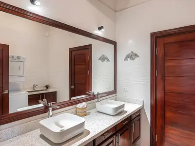 a bathroom with two sinks and a large mirror at Surfside Apartments - Playa Mar Azul in Mal País
