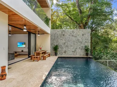 a swimming pool in the backyard of a house at Surfside Apartments - Playa Mar Azul in Mal País