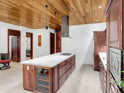 a kitchen with wooden ceilings and a counter top at Surfside Apartments - Playa Mar Azul in Mal País