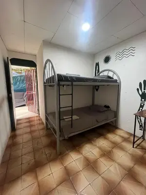 a room with bunk beds in a room at Casa bohio surf in Jacó