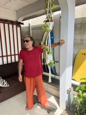 a man standing on a skateboard in a room at Casa bohio surf in Jacó