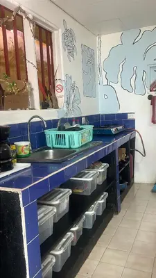 a blue counter with dishes on it in a kitchen at Casa bohio surf in Jacó