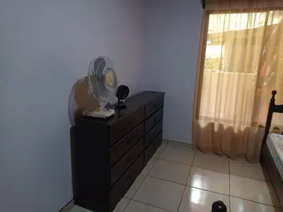 a bedroom with a dresser with a fan on it at Casa huéspedes Noe in Coronado