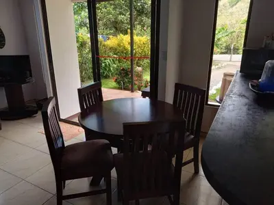 a dining room with a wooden table and chairs at Casa huéspedes Noe in Coronado