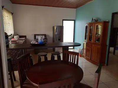a kitchen with a table and chairs and a refrigerator at Casa huéspedes Noe in Coronado