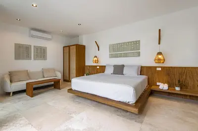 a bedroom with a large bed and a couch at Villa Bahia Oceanview Designer Retreat Malpais in Mal País