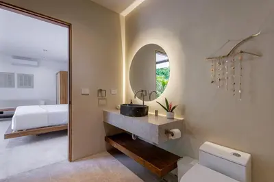 a bathroom with a sink and a bed and a mirror at Villa Bahia Oceanview Designer Retreat Malpais in Mal País