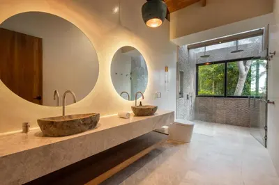 two sinks in a bathroom with two mirrors at Villa Bahia Oceanview Designer Retreat Malpais in Mal País