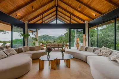 a living room with couches and a table at Villa Bahia Oceanview Designer Retreat Malpais in Mal País