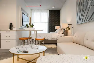 a living room with a couch and a table at Escalante Executive Studio AC in San José