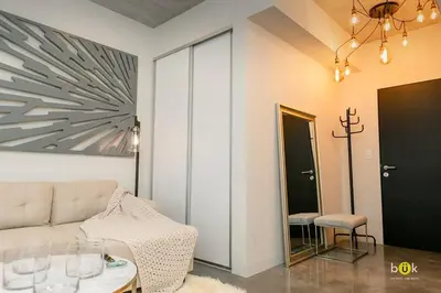 a living room with a couch and a table at Escalante Executive Studio AC in San José