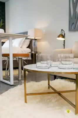 a living room with a table with glasses on it at Escalante Executive Studio AC in San José