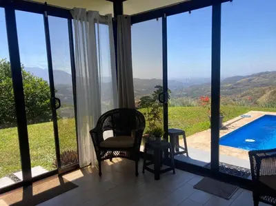 a living room with a view of a swimming pool at Agradable casa de Campo con Piscina privada in Escobal
