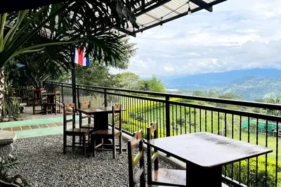 a table and chairs on a balcony with a view at Cabaña La Finca in Cervantes