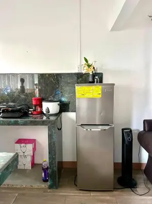 a kitchen with a refrigerator and a counter at Miravalles Tiny House in Upala