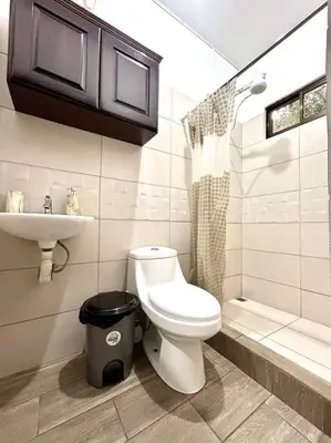 a bathroom with a toilet and a sink at Miravalles Tiny House in Upala