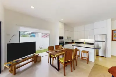 a kitchen with a table and chairs and a tv at Casa Corales Dreams Deluxe in Playa Flamingo
