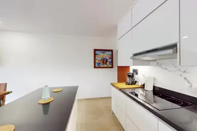 a kitchen with white cabinets and a counter top at Casa Corales Dreams Deluxe in Playa Flamingo