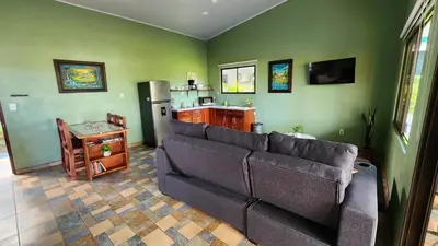 a living room with a couch and a kitchen at Casa tipica in Fortuna