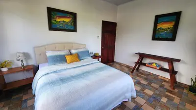 a bedroom with a large bed and a table at Casa tipica in Fortuna