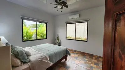 a bedroom with a bed and two windows at Casa tipica in Fortuna