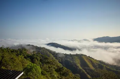 a view of a mountain with clouds in the valley at Nosara Hideaway 3 - BREAKFAST PROVIDED & Mountain View Cabins in Nosara