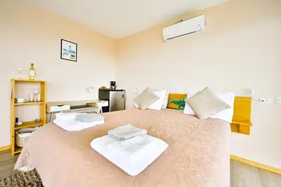 a bedroom with a large bed with towels on it at Nosara Hideaway 3 - BREAKFAST PROVIDED & Mountain View Cabins in Nosara