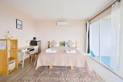 a bedroom with a bed and a desk and a window at Nosara Hideaway 3 - BREAKFAST PROVIDED & Mountain View Cabins in Nosara