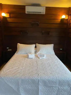 a white bed with two white plates on it at Sol y Luna Chalet in Fortuna