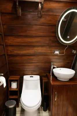 a bathroom with a toilet and a sink at Sol y Luna Chalet in Fortuna