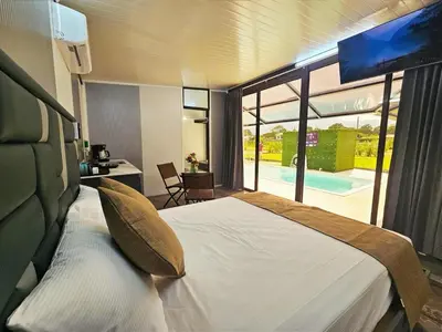 a bedroom with a bed and a view of a pool at Casa Cristal # 1 in Fortuna