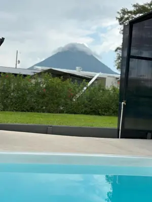 a swimming pool with a fountain in front of a house at Casa Cristal # 1 in Fortuna