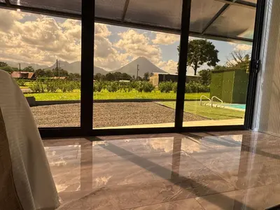 a room with a view of a pool seen through a window at Casa Cristal # 1 in Fortuna