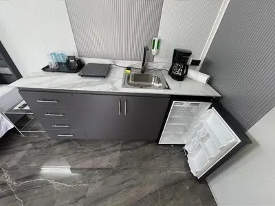 a kitchen with a sink and an open refrigerator at Casa Cristal # 1 in Fortuna
