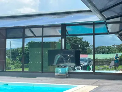 a living room with a tv and a swimming pool at Casa Cristal # 1 in Fortuna
