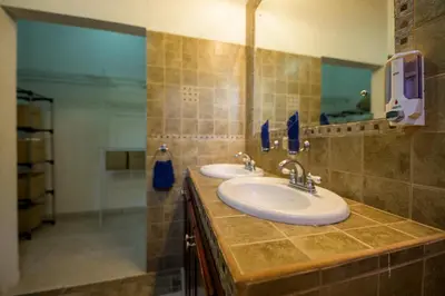 a bathroom with two sinks and a shower at Jungle & Beach Retreat Villa Tranquilo in Esterillos Este