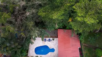 an overhead view of a red garage with a blue door at Jungle & Beach Retreat Villa Tranquilo in Esterillos Este
