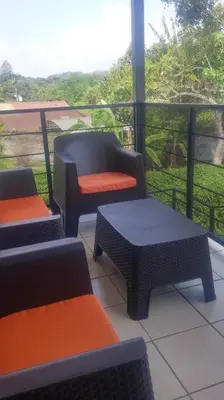 a balcony with chairs and a table and a window at Apto D Laidman y Raabe SRL in Mercedes