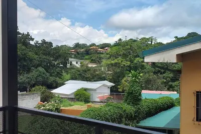 a balcony with a view of a house and a pool at Apto D Laidman y Raabe SRL in Mercedes