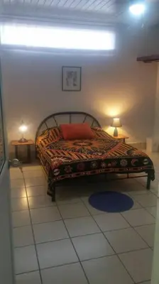 a bedroom with a bed with two lamps on the floor at Apto D Laidman y Raabe SRL in Mercedes