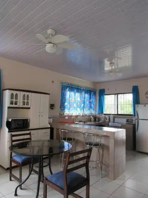 a kitchen with a table and some chairs and a counter at Apto D Laidman y Raabe SRL in Mercedes